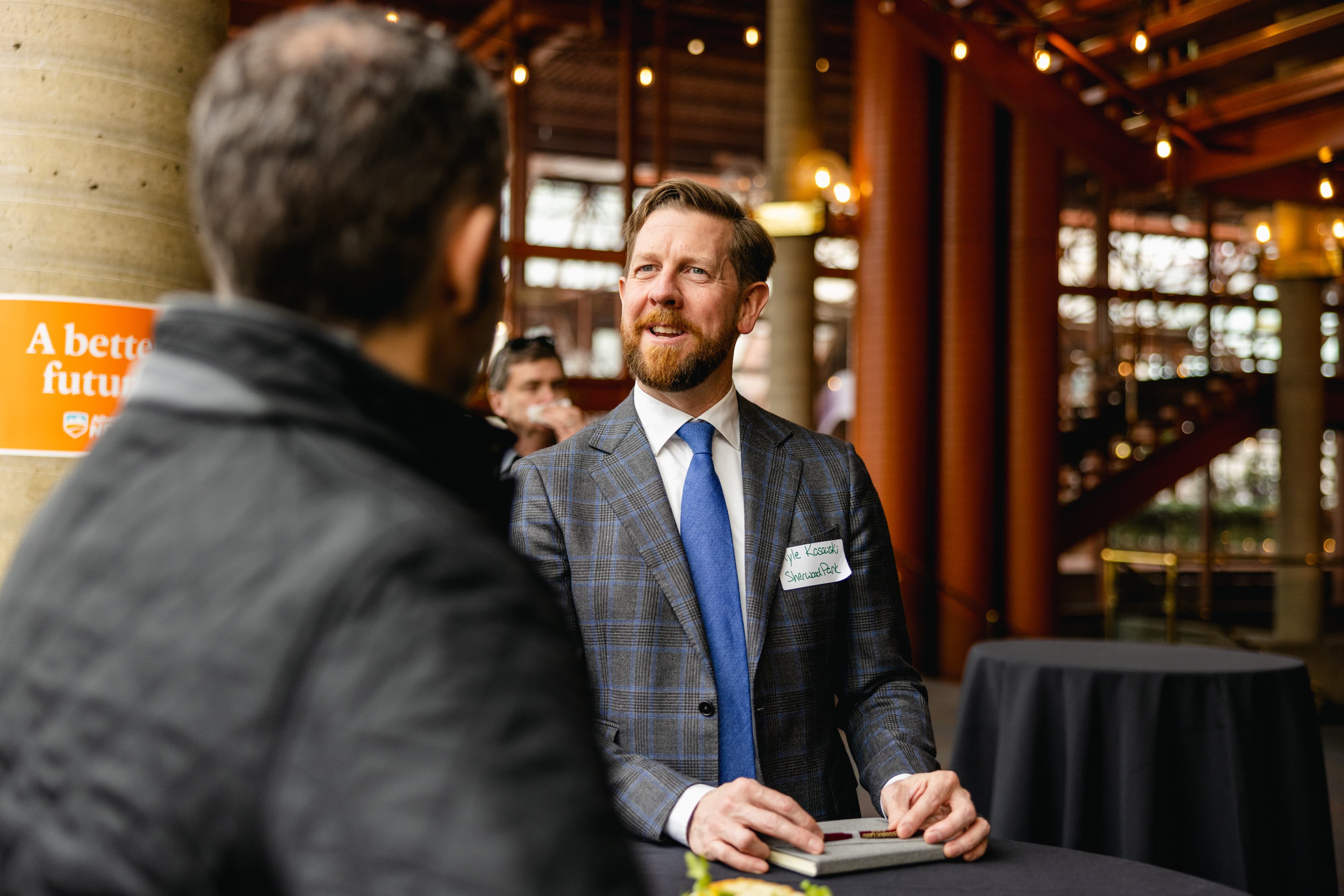 Kyle Kasawski speaking with a local teacher